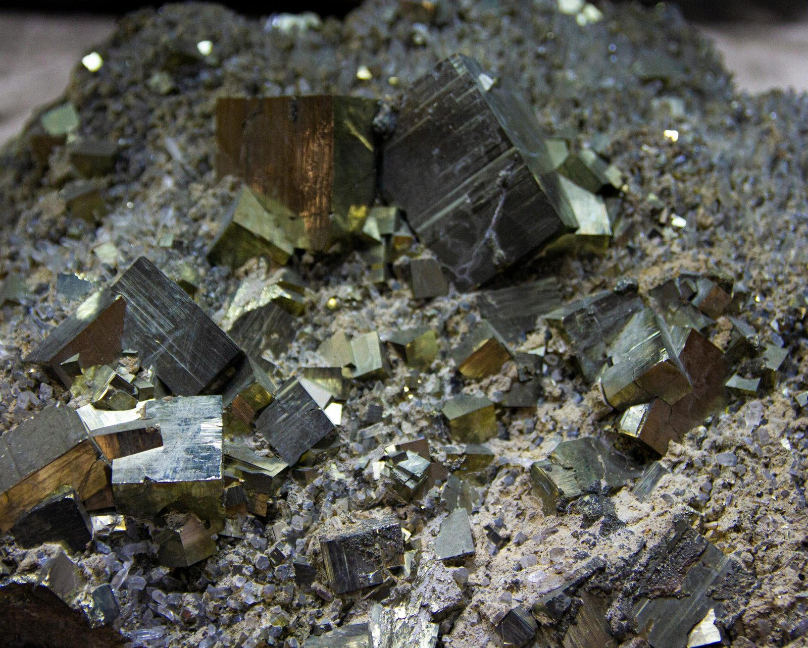 Detailed close-up of pyrite crystal formations showcasing geometric gold and silver tones.