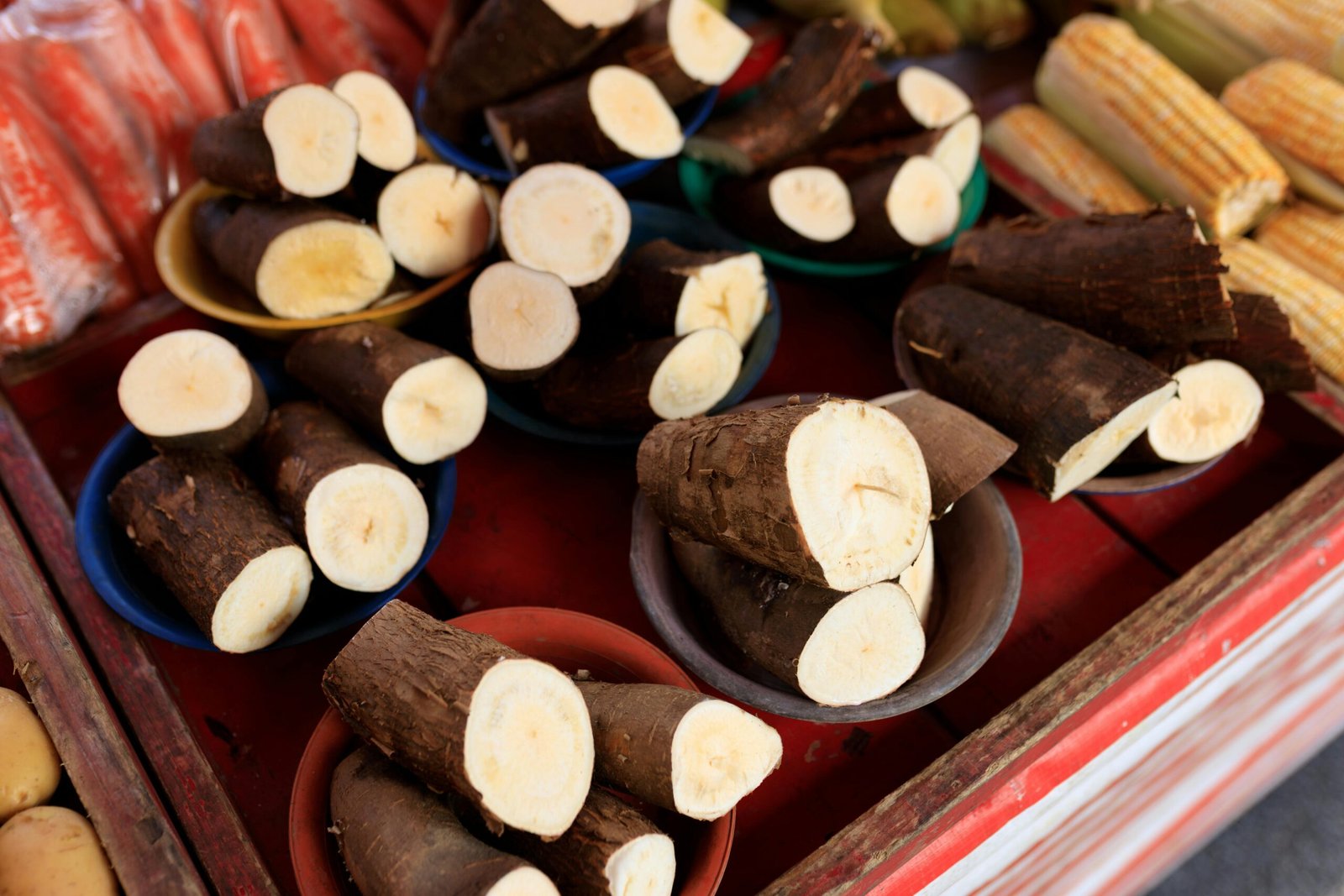 Sliced cassava on display at a market stall, offering fresh produce for sale.